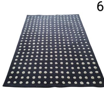 Asiatic rug from the Dotty Navy collection with a handmade 3D polka dot design for rent for events, advertising, films and series.