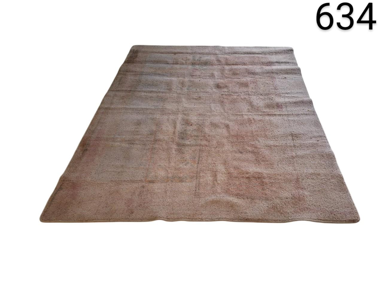 Hand knotted vintage turkish rug, characterised by its faded tone and subtle woven texture, rental for events, advertising, films and series.