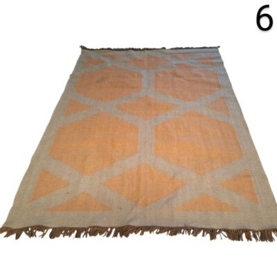 Geometric hand-woven carpet with fringes for rent for events, advertising, films and series.