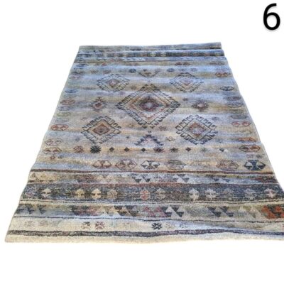 Vintage Turkish Oushak style carpet with geometric motifs in beige and blue tones for rent for events, advertising, films and series.