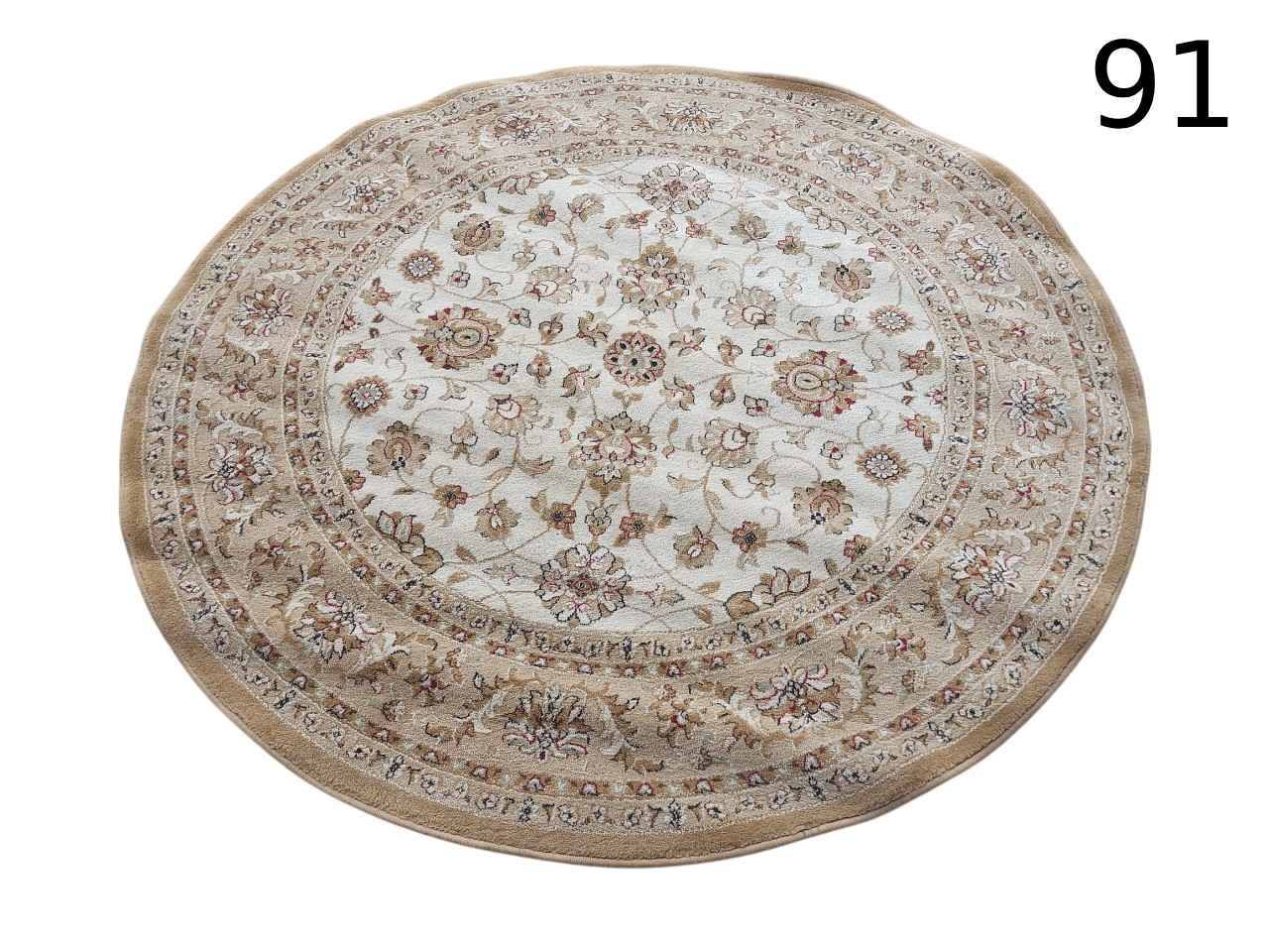 Round Tabriz style rug with intricate floral patterns in beige and brown tones for rent for events, advertising, films and series.