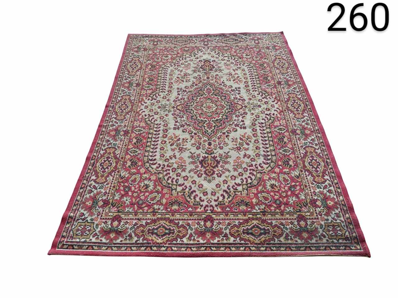 Persian or oriental style carpet with a central floral medallion detailed in pink and beige tones for rent for events, advertising, films and series.