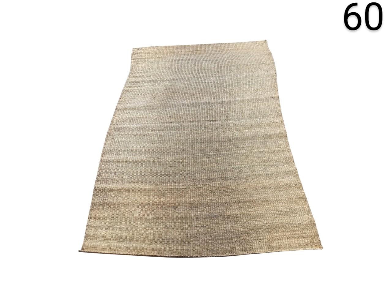 Rectangular rug made of beige natural jute fibre with a rustic braided weave for rent for events, advertising, films and series.