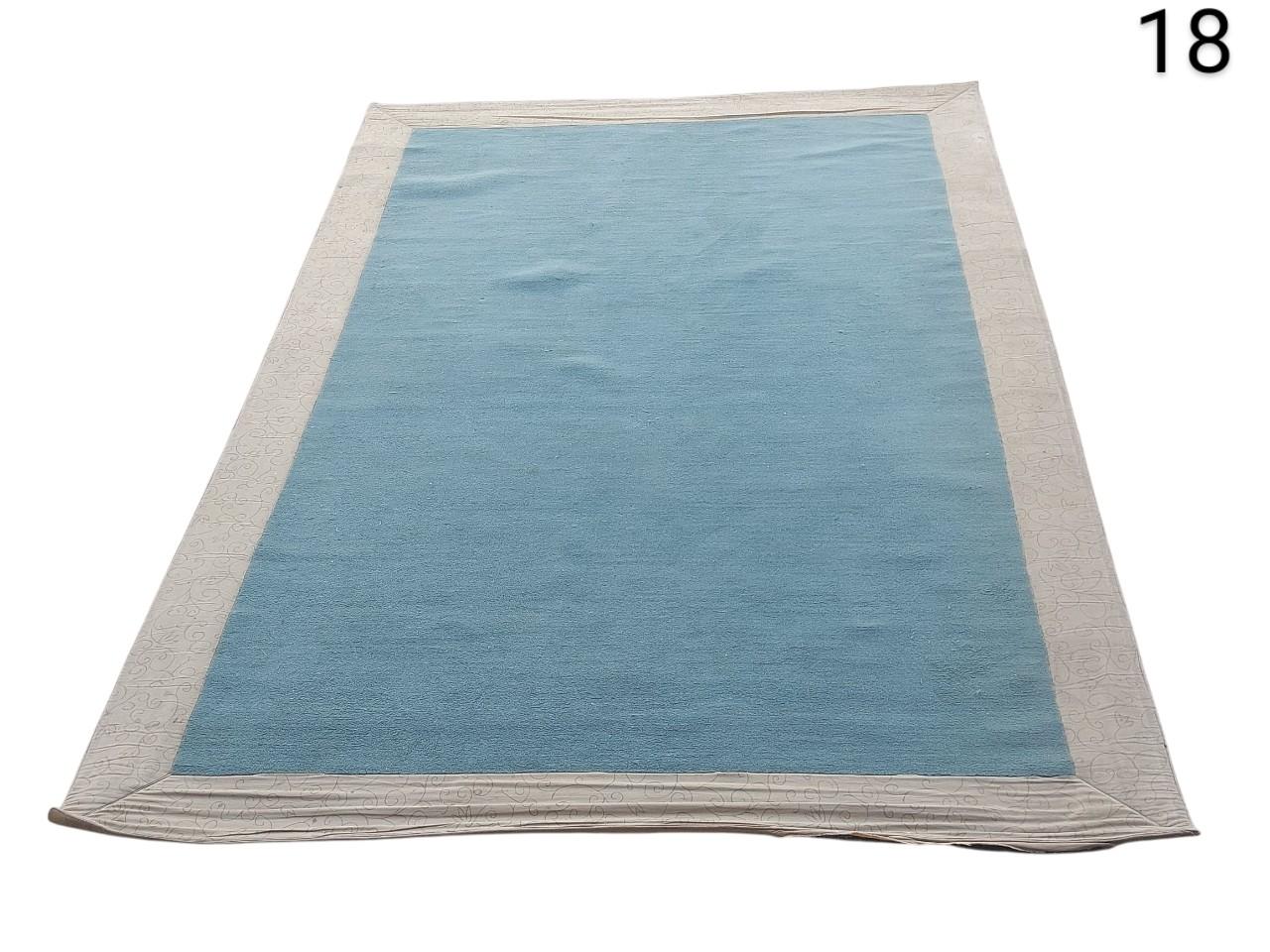 Greenish blue wool carpet with natural border Laura Ashley style for rent for events, advertising, movies and series.