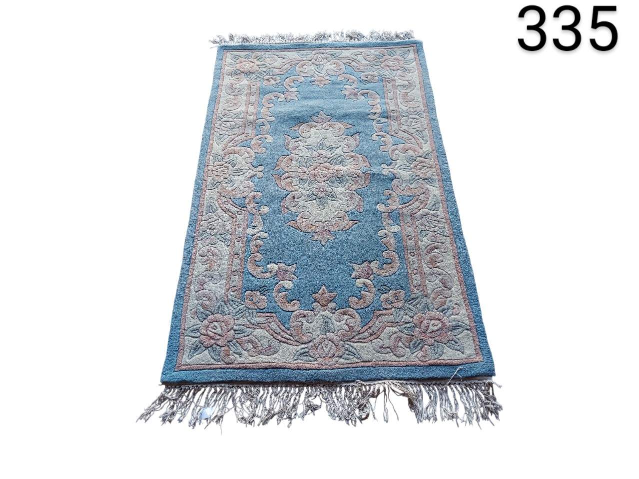 Aubusson style woollen carpet with traditional floral design and fringed edges for hire for events, advertising, films and series.