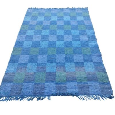 Handmade wool rug with blue and green checkered design for rent for events, advertising, movies and series.