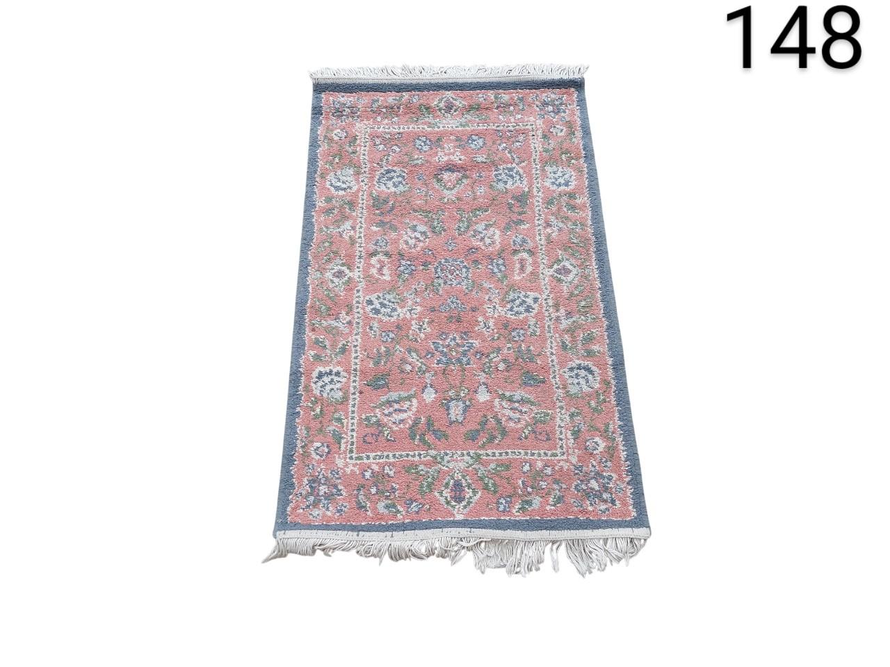 Persian style pink woollen carpet, possibly Indo-Persian or Sarouk pattern, with intricate floral details, for rental for events, advertising, films and series.