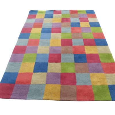 Handmade wool rug designed by Nanimarquina with a multicoloured checkered pattern for rent for events, advertising, films and series.