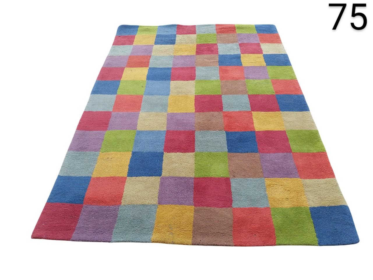 Handmade wool rug designed by Nanimarquina with a multicoloured checkered pattern for rent for events, advertising, films and series.