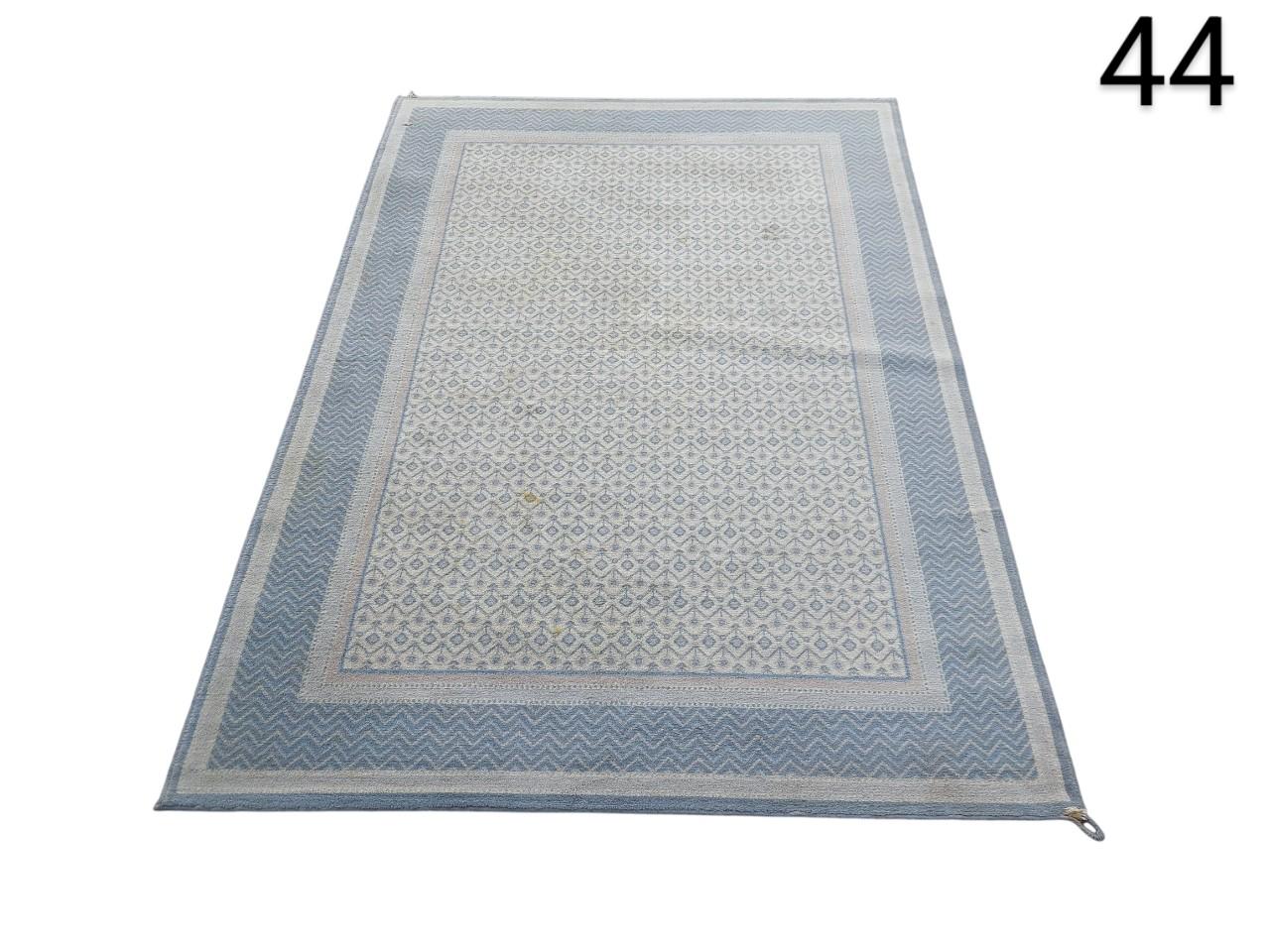 handwoven cotton dhurrie rug with blue and white geometric print for rent for events, advertising, movies and series.