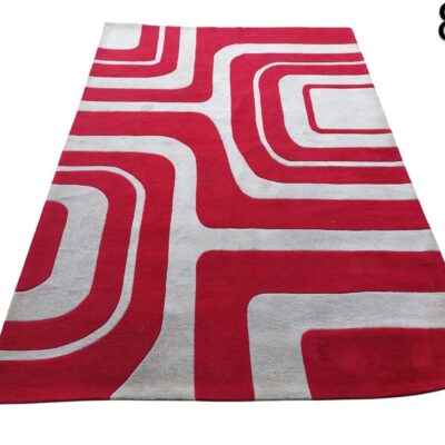 Geometric mid-century retro style carpet with a wavy design in red and white colours for rent for events, advertising, films and series.