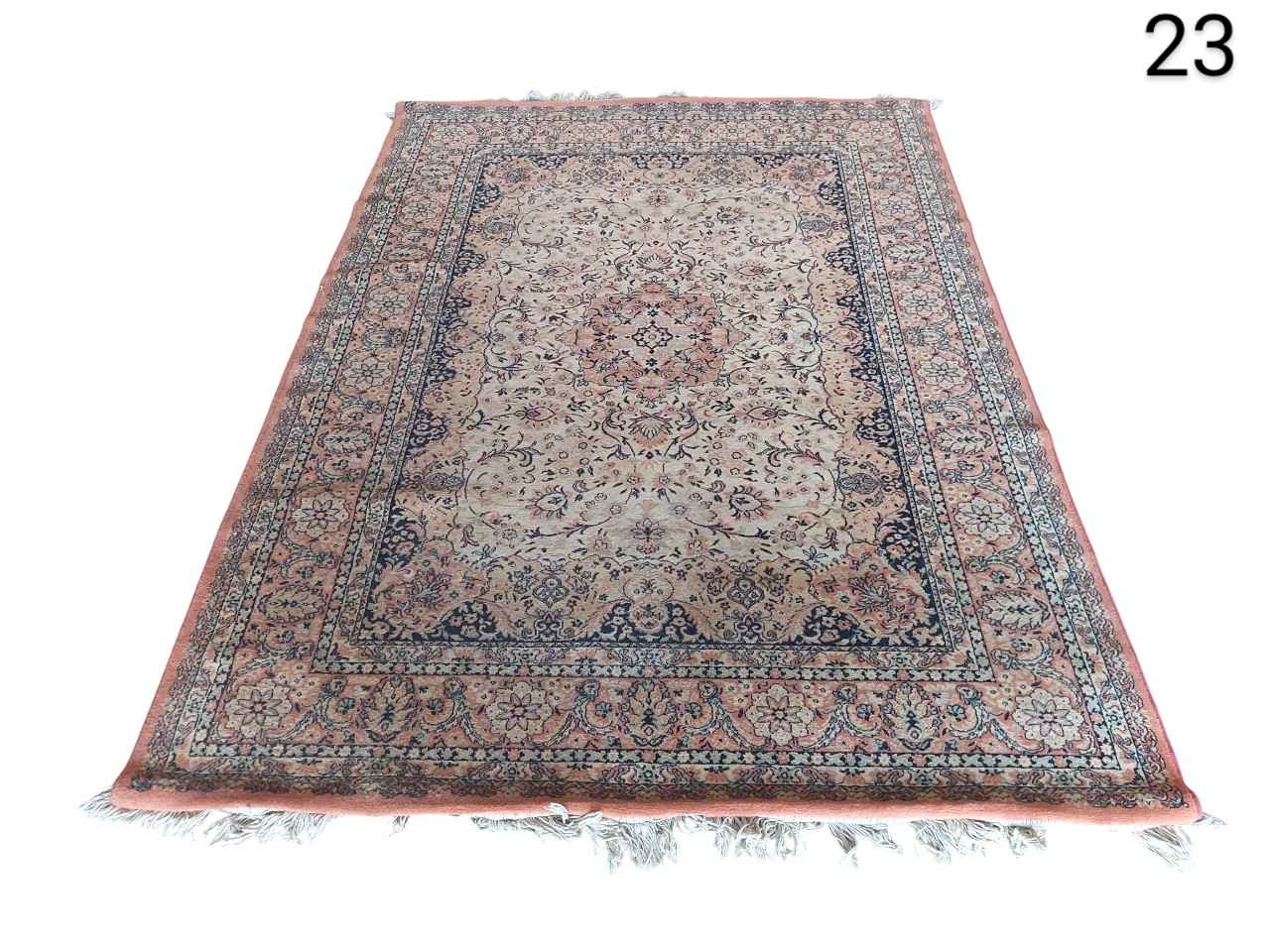 Handmade oriental rug, possibly Persian or Kashmiri style, with pink and blue tones.