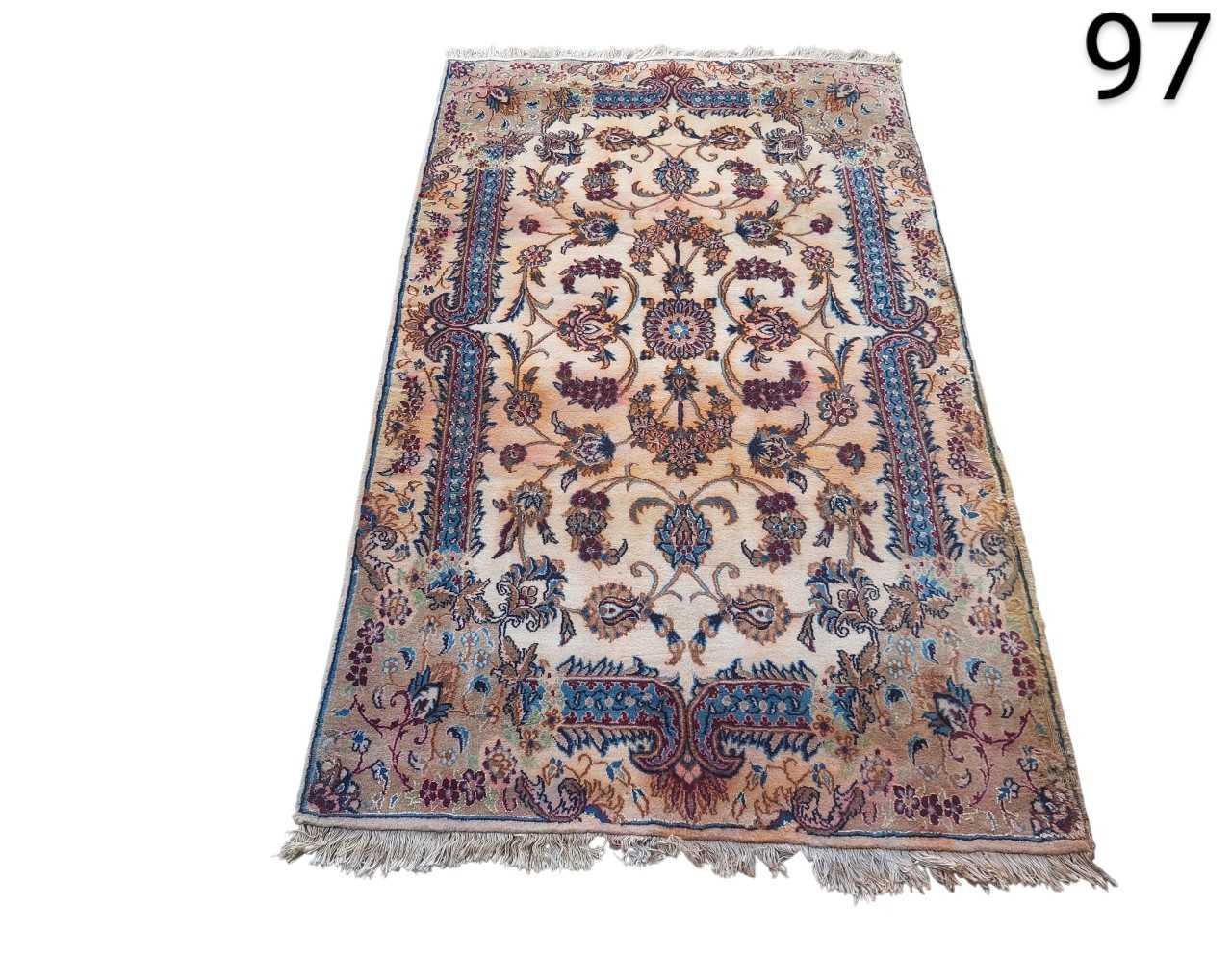 This is a detailed Isfahan Persian rug with a central medallion design on a cream background and blue borders. rental for events, advertising, films and series.