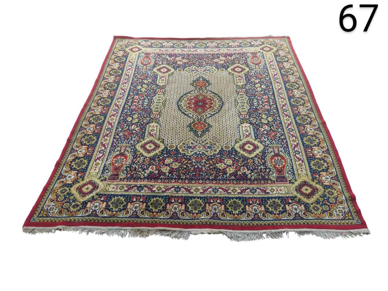 Persian style carpet with a traditional central medallion design and geometric motifs in red, blue and beige colours for rent for events, advertising, films and series.