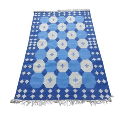 Hand-woven carpet with blue tile design is an Indian Dhurrie made of cotton for rent for events, advertising, films and series.