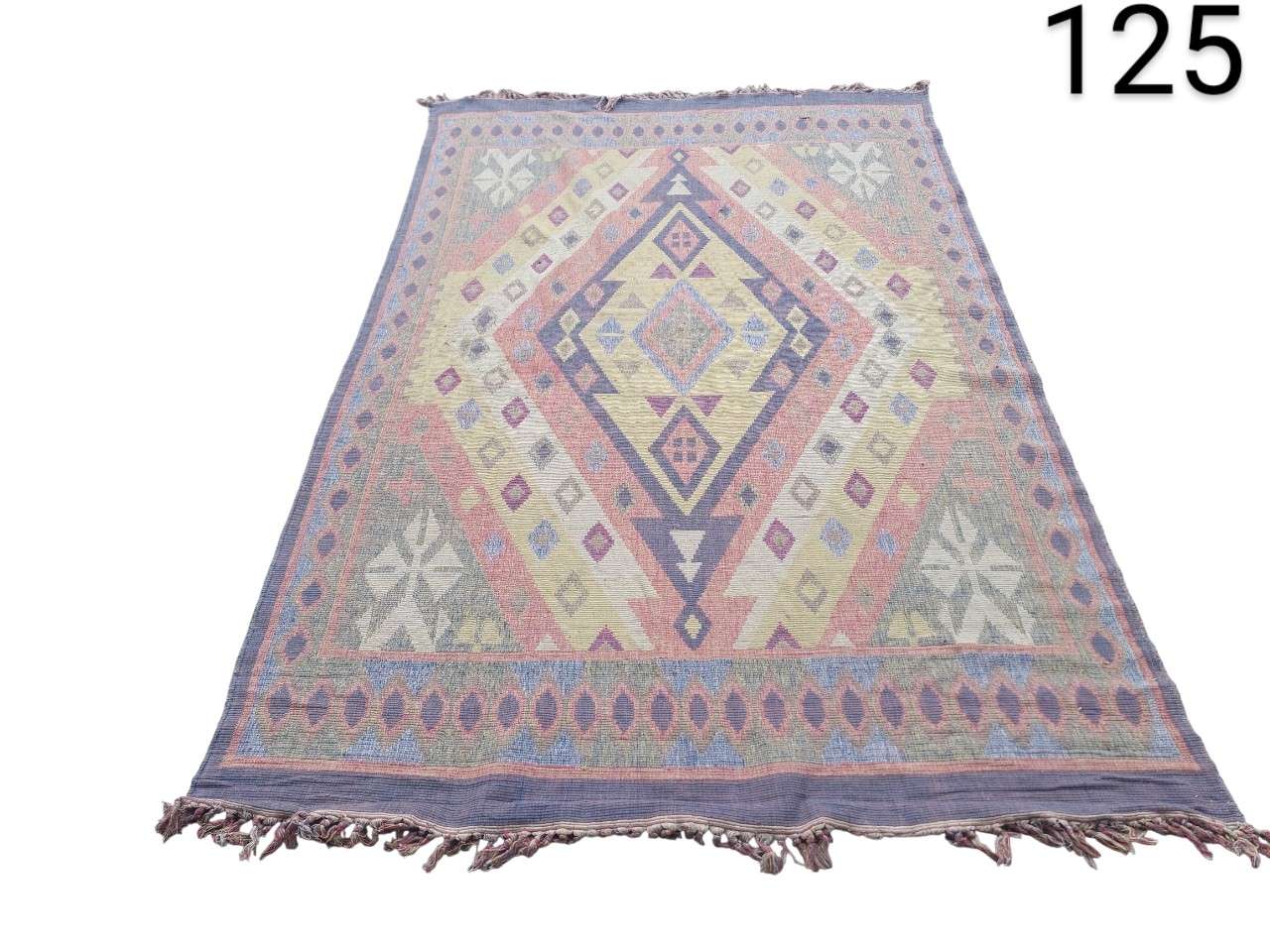 Hand-woven Kilim type rug with geometric design and pastel tones for rent for events, advertising, films and series.