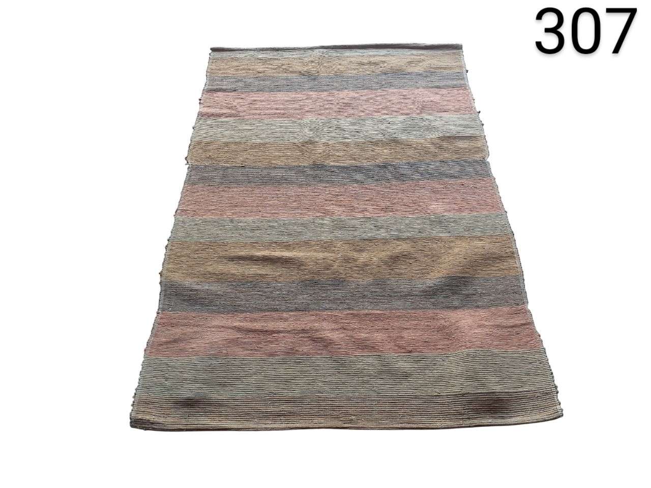 Hand-woven kilim rug with a horizontal striped design in earth tones like brown, pink and grey for rent for events, advertising, films and series.