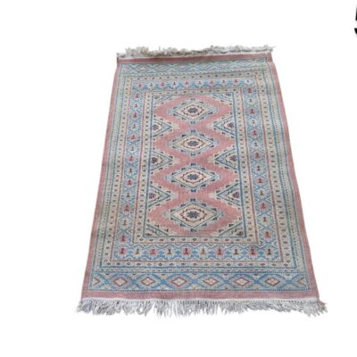 Handmade vintage turkish rug with geometric patterns in pink and blue tones for rent for events, advertising, movies and series.