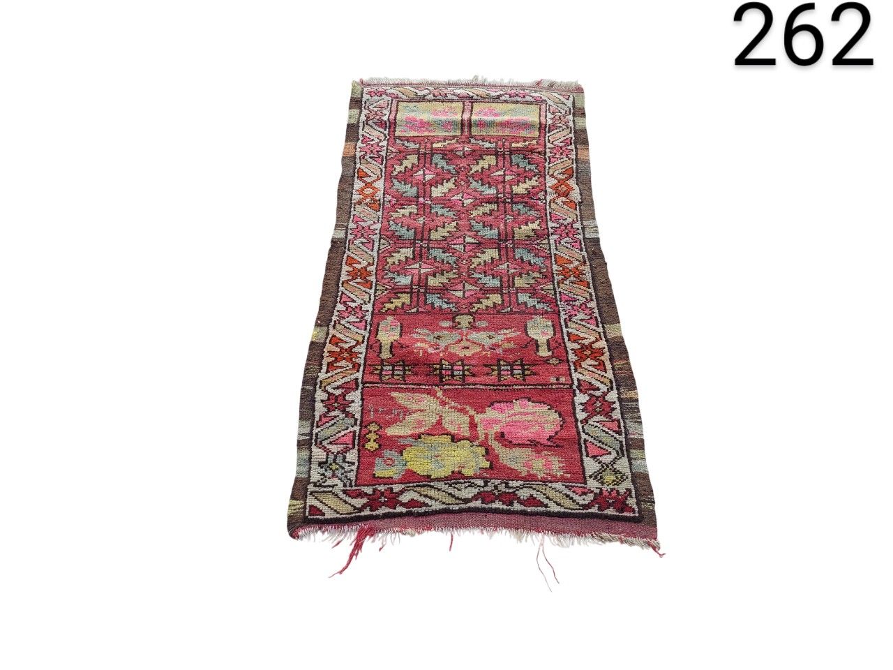 Decorative vintage hallway rug with a geometric pattern in pink and red tones for rent for events, advertising, films and series.