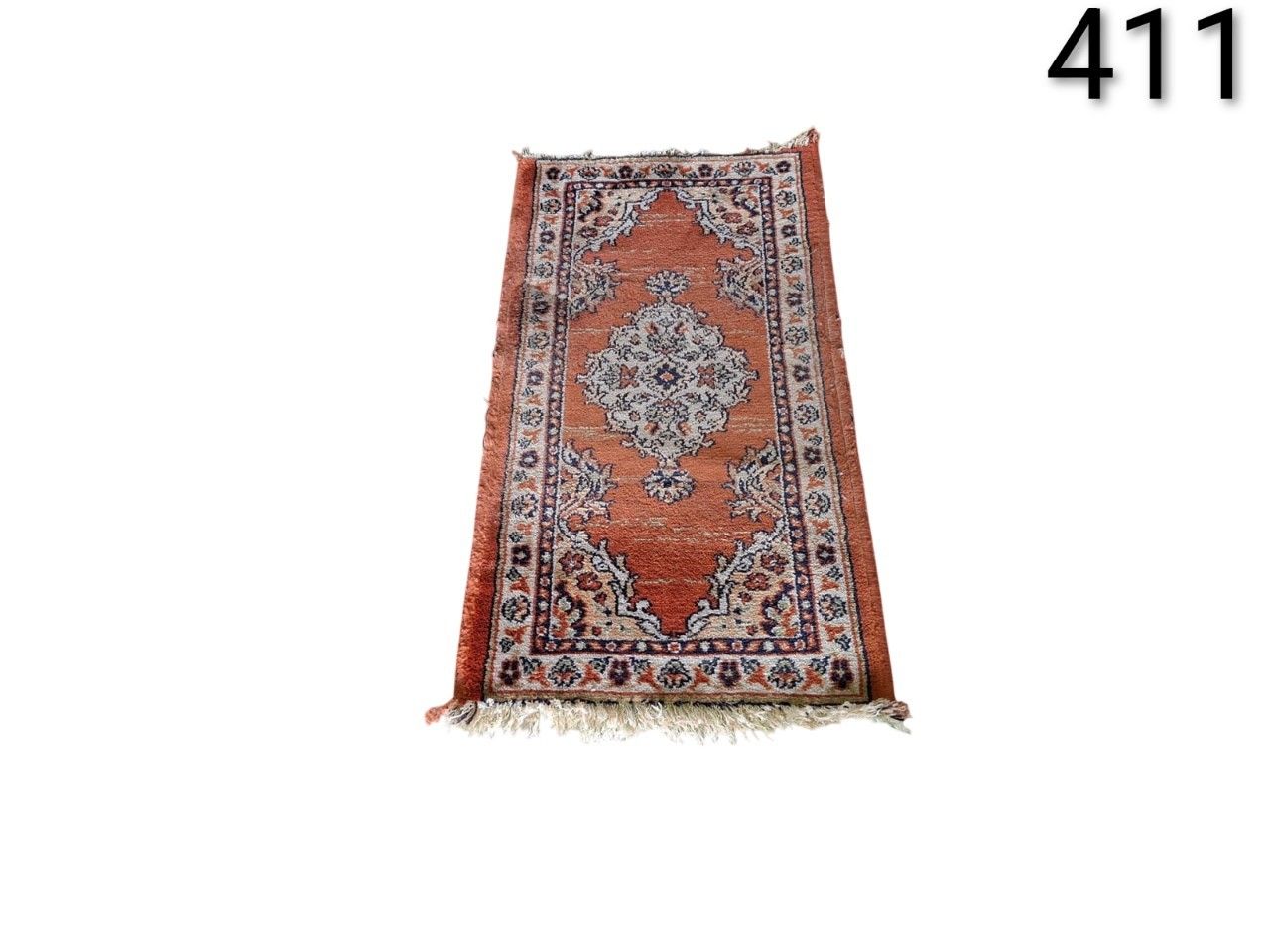 Small Persian or Turkish style hand knotted carpet, with a central floral medallion design in rust red and beige colours, for rent for events, advertising, film and series.