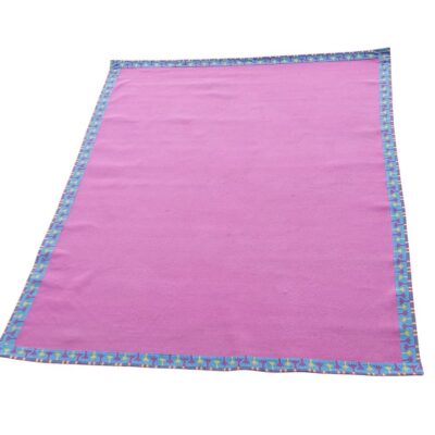 Cobija de color rosa con un borde estampado colorido alquiler para eventos, publicidad, series y peliculas
