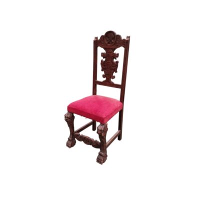 Carved wooden chair in the Spanish Renaissance style, upholstered in red velvet, available for hire for events, advertising, films and TV series