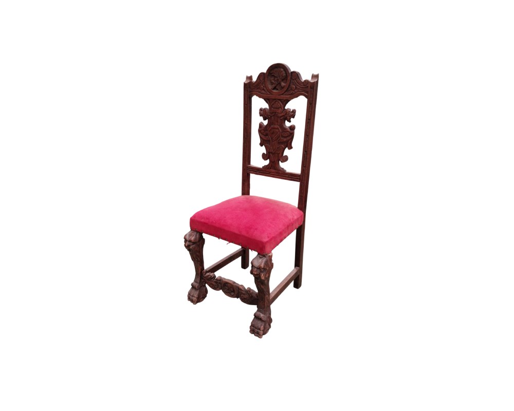 Carved wooden chair in the Spanish Renaissance style, upholstered in red velvet, available for hire for events, advertising, films and TV series