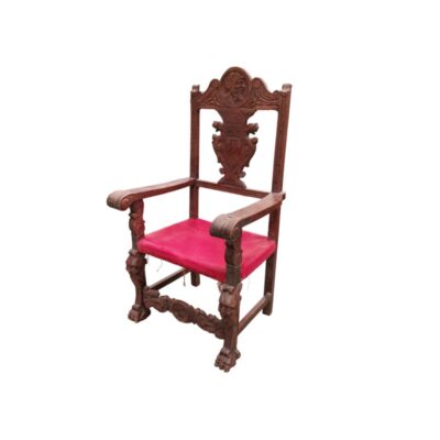 Spanish Renaissance-style armchair featuring a wooden frame carved with heraldic motifs and a seat upholstered in red velvet; available for hire for events, advertising, films and TV series