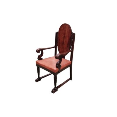 A Renaissance-style or early Castilian-style chair featuring a carved wooden frame and a red upholstered seat, available for hire for events, advertising, films and TV series