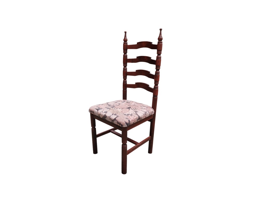 Antique Sevillian chair featuring a carved wooden frame and a seat upholstered with a floral pattern; available for hire for events, advertising, films and TV series