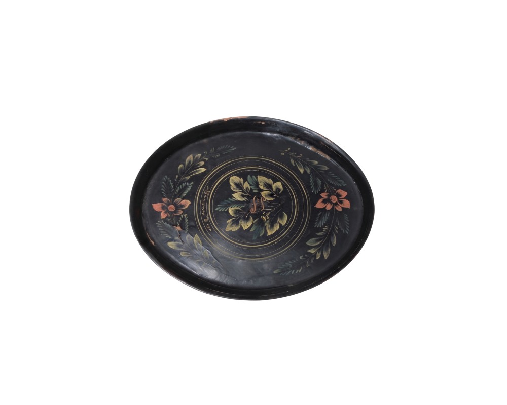 a tray with a dark-coloured finish, featuring an interior surface decorated with hand-painted floral and plant motifs in soft shades such as green, cream and salmon, arranged in the centre and flanked by garlands; available for hire for events, advertising, films and TV series