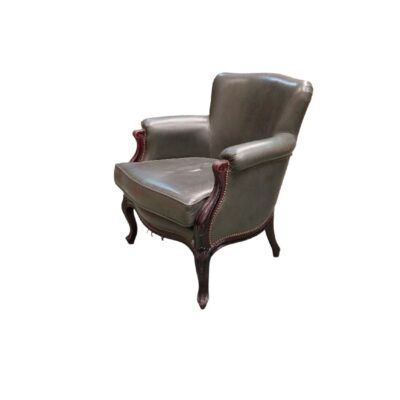 This antique Louis XV-style armchair is upholstered in grey leather and features a carved walnut frame; available for hire for events, advertising, films and TV series