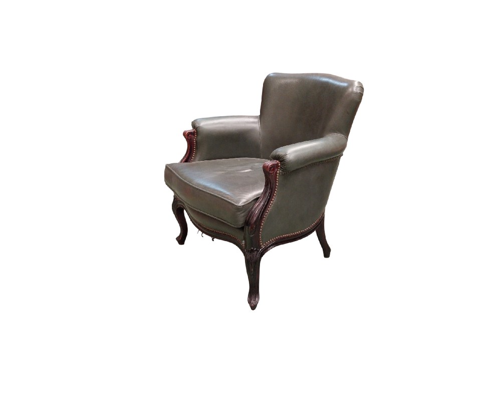 This antique Louis XV-style armchair is upholstered in grey leather and features a carved walnut frame; available for hire for events, advertising, films and TV series