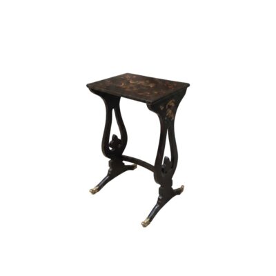 A small side table in dark tones, characterised by a rectangular top decorated with delicate gold motifs, curved side supports with a stylised design, and legs with metal finials; available for hire for events, advertising, films and TV series