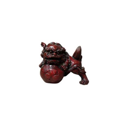 Ornamental sculpture depicting a traditional guardian lion (or Foo dog), carved with a dark reddish finish; available for hire for events, advertising, films and TV series