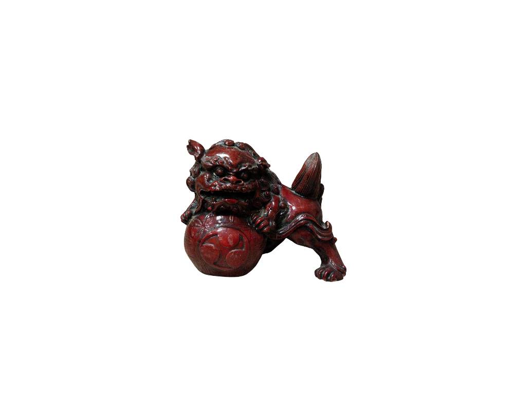 Ornamental sculpture depicting a traditional guardian lion (or Foo dog), carved with a dark reddish finish; available for hire for events, advertising, films and TV series
