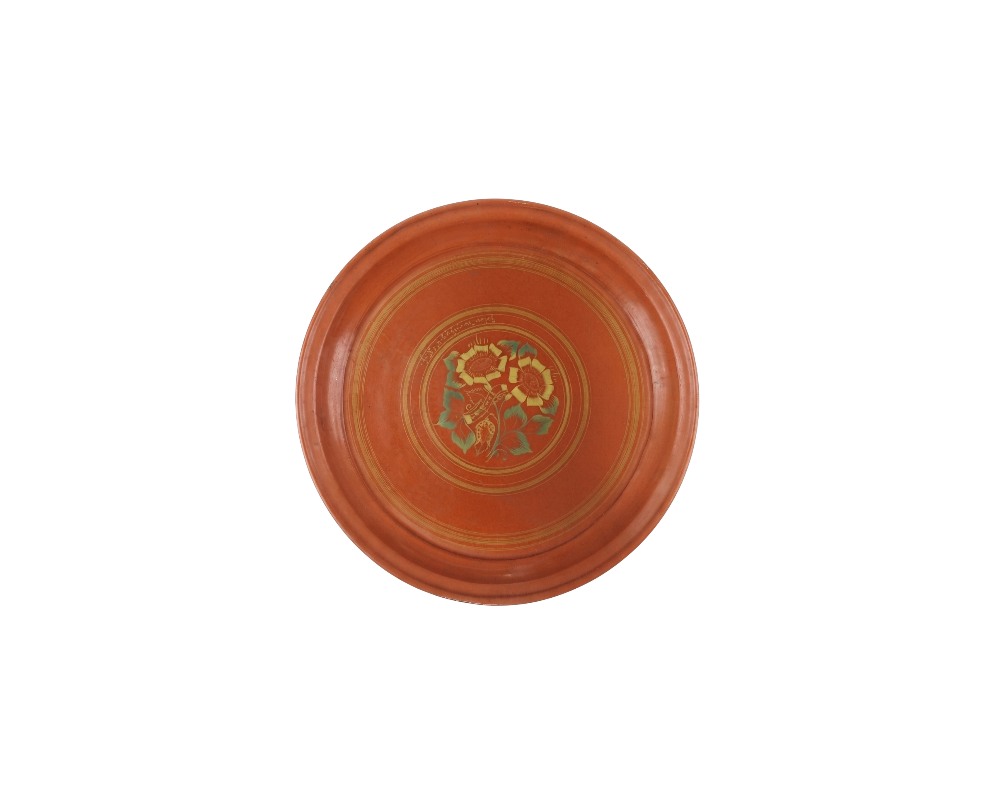 comprising four ceramic pieces in circular and octagonal shapes, finished in shades of terracotta and ochre, characterised by raised rims and an interior surface decorated with floral and geometric motifs painted in fine detail; available for hire for events, advertising, films and TV series