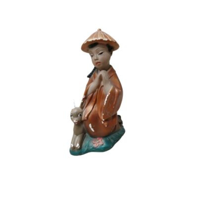 The statuette depicts a young figure dressed in traditional clothing, including a conical hat, in a prayerful pose. Available for hire for events, advertising, films and TV series.