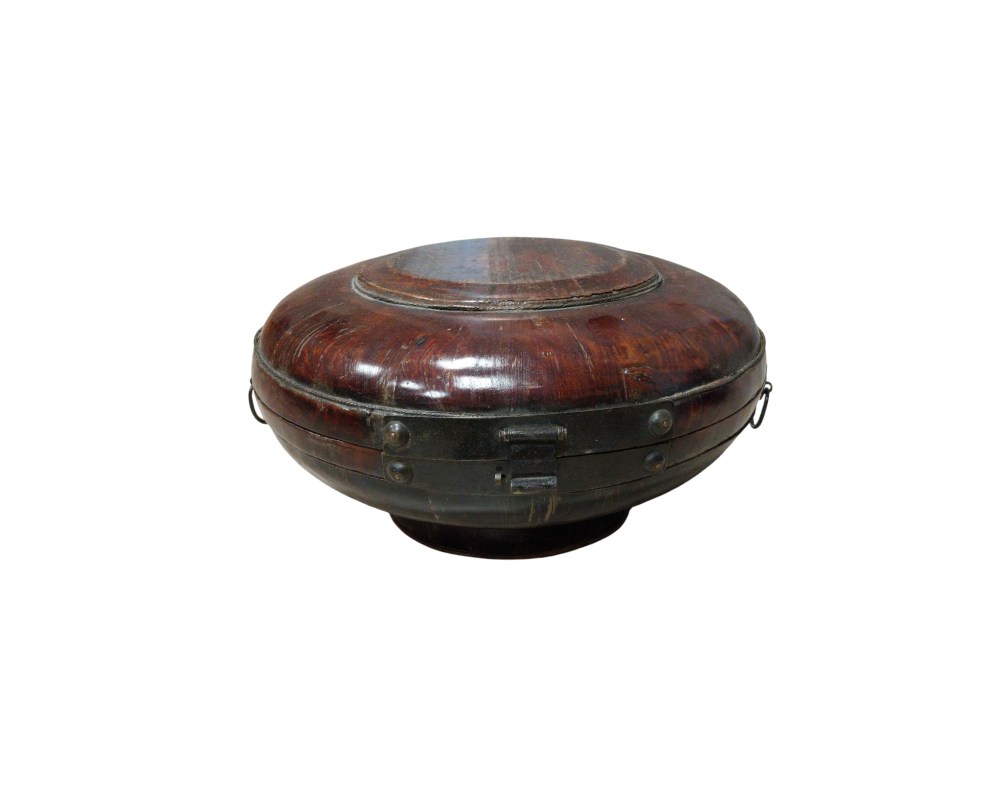 A traditional, rounded and domed container, made of wood with a polished finish in dark and reddish tones; available for hire for events, advertising, films and TV series