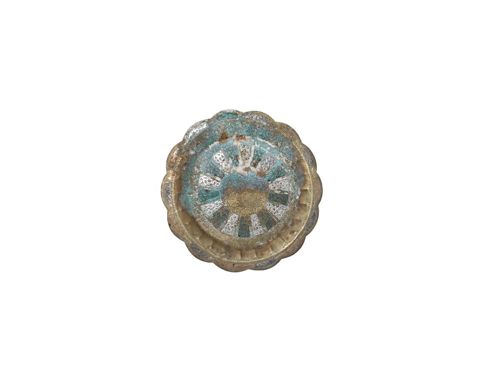 A metal tray with a wavy, lobed rim, featuring a distinct greenish rust patina and areas worn by the passage of time; available for hire for events, advertising, films and TV series