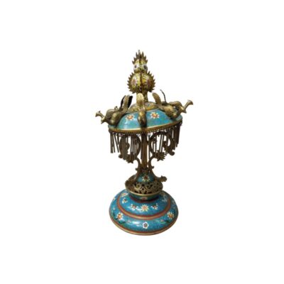 A traditional-style decorative table centrepiece, featuring a base and an upper dome with cloisonné enamel in shades of blue and floral motifs, adorned with metal bird figures at the top and a skirt of metal pendants; available for hire for events, advertising, films and TV series