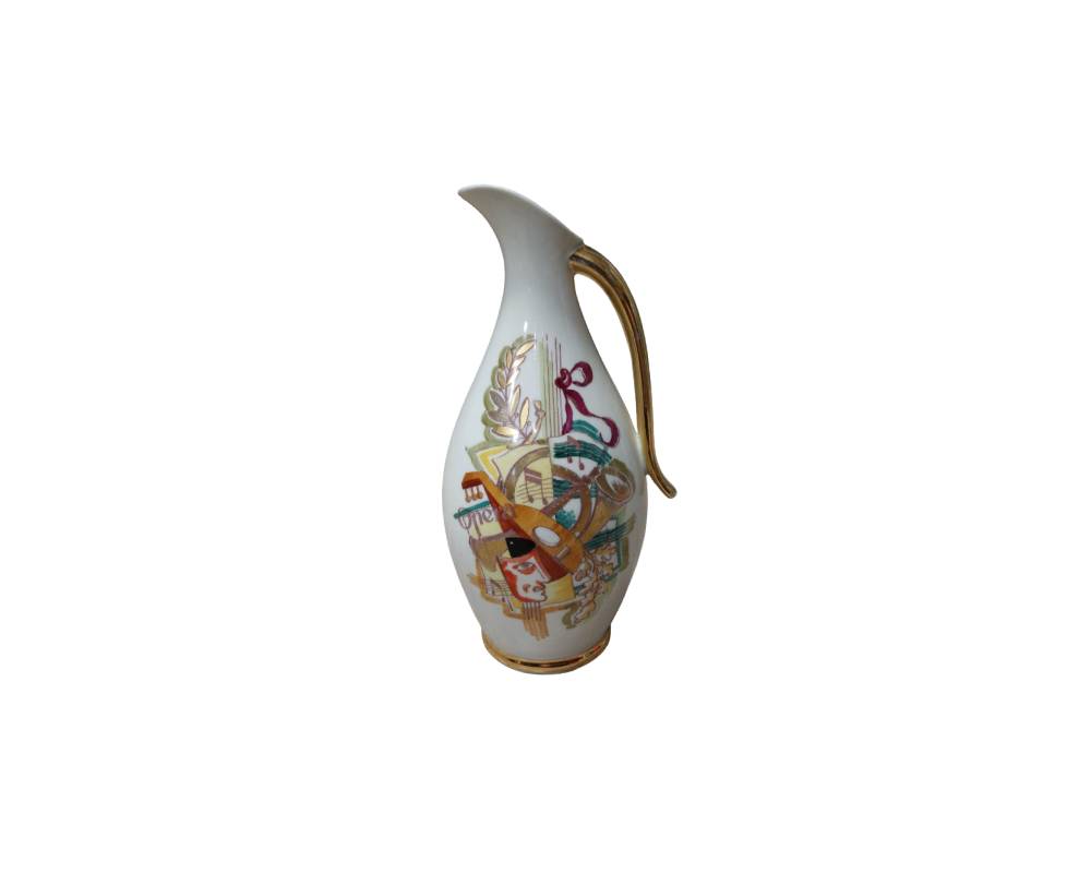 An elegant porcelain jug with a white base, a rounded body and a sloping spout, decorated with a central design inspired by the world of opera, featuring instruments and graphic elements in colourful tones. Available for hire for events, advertising, films and TV series.
