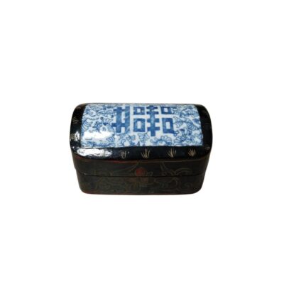 A traditional-style rectangular jewellery box, characterised by its black-lacquered wooden body with subtle floral decorations engraved on the sides. The lid features a central inlay of blue and white porcelain. Hire for events, advertising, films and TV series