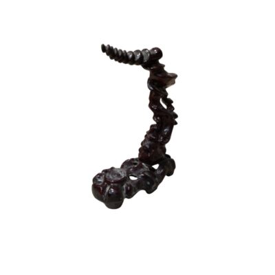 A decorative vertical display stand made from dark wood, featuring carvings that evoke organic, flowing shapes; available for hire for events, advertising, films and TV series