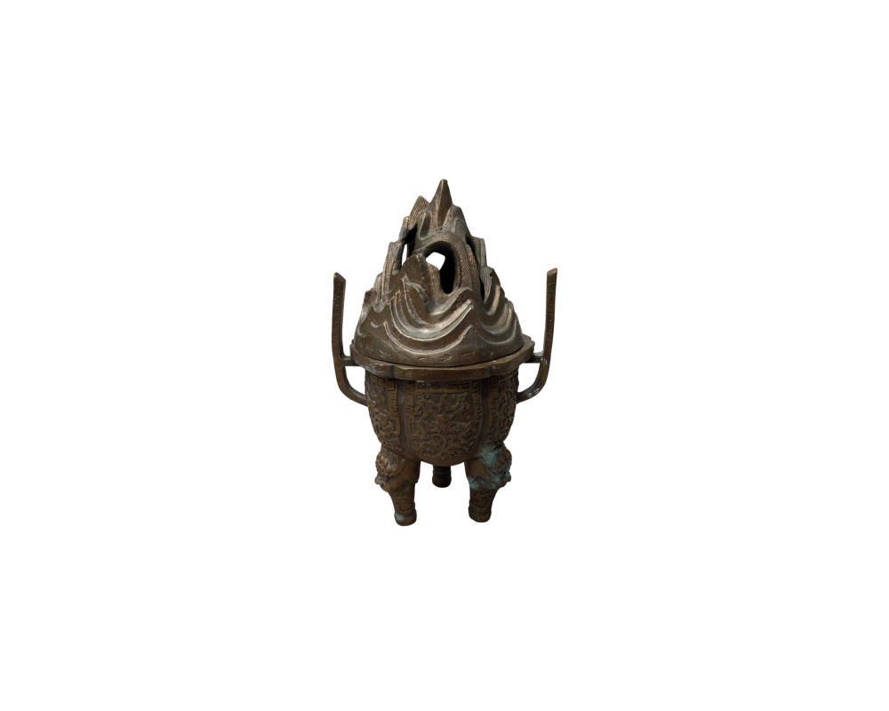 A bronze censer with a dark, antiqued finish, characterised by a spherical body resting on three legs, two vertical handles on the sides and an elaborately sculpted lid featuring designs resembling mountains or rock formations. Available for hire for events, advertising, films and TV series