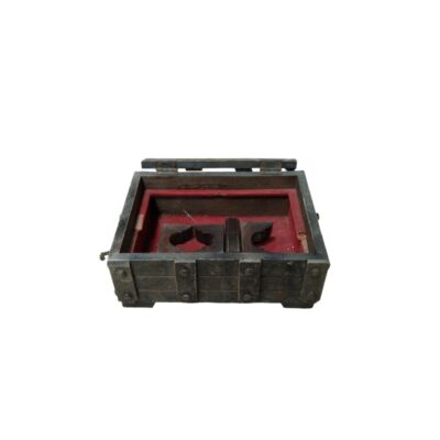 A rectangular wooden chest with dark external fittings and an aged finish, featuring an interior compartment lined with red fabric and fitted with uniquely designed internal supports; available for hire for events, advertising, films and TV series