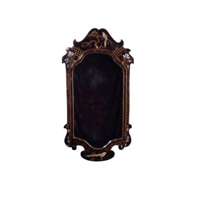 Vertical wall mirror with a dark frame featuring sinuous, cut-out shapes, characterised by delicate mother-of-pearl inlays and gilded details depicting motifs of birds, branches and flowers; available for hire for events, advertising, films and TV series