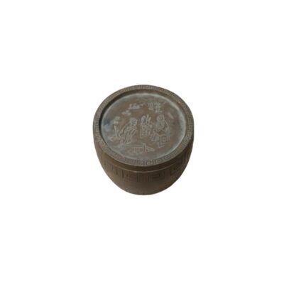 A cylindrical metal vessel with a dark, aged finish, characterised by a surface decorated with classical-style geometric borders and a lid featuring detailed linear engravings depicting human figures in a traditional setting and oriental characters; available for hire for events, advertising, films and TV series