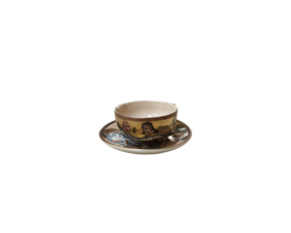 a ceramic cup and saucer featuring a cohesive and detailed design. The exterior of the cup and the surface of the saucer are adorned with pictorial depictions of figures from the worlds of event hire, advertising, films and TV series