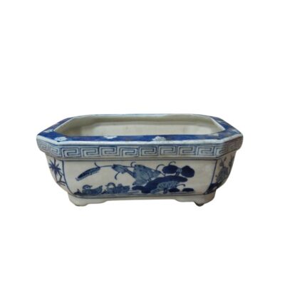 A rectangular flowerpot with octagonal edges, made of porcelain. It is decorated using the traditional cobalt blue technique on a white background, featuring aquatic scenes; available for hire for events, advertising, films and TV series